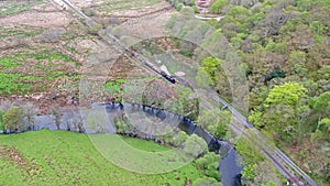 Aerial view of Steamtrain driving through the Snowdonia National Park in Wales - United Kingdom