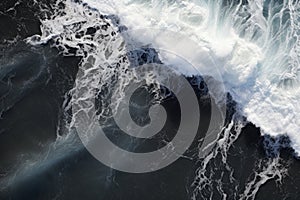Aerial view of stormy ocean waves breaking on black sand beach, Aerial view of waves on the black sand beach, AI Generated