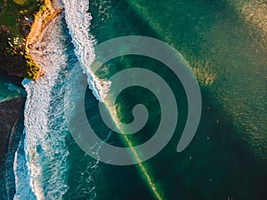 Aerial view of stormy waves at sunset. Biggest ocean wave with green tones