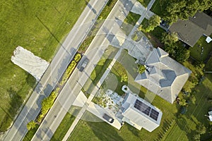 Aerial view of street traffic with driving cars in small town America suburban landscape with private homes between