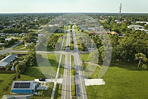 Aerial view of street traffic with driving cars in small town America suburban landscape with private homes in Florida