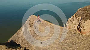 aerial view of stretching exercises outdoors. drone flight around fitness woman jogger doing exercises and stretches at