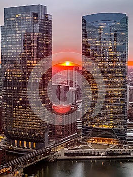 Aerial view of stunning ball of sun creating deep orange sunset over Chicago Loop photo