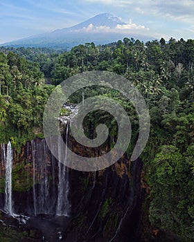 Aerial view of the stunning Lumajang Sewu Waterfall in Indonesia, surrounded by lush tropical forest