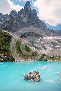 Aerial view, stunning panoramic view of the Lake Sorapis, Lago di Sorapis, with turquoise water surrounded by green