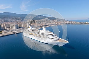 Aerial view of stunning white cruise ship on luxurious ocean waters on a beautiful sunny day