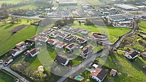 Aerial view of suburban landscape with private homes between green fields in quiet french residential area