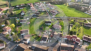 Aerial view of suburban landscape with private homes between green fields in quiet french residential area