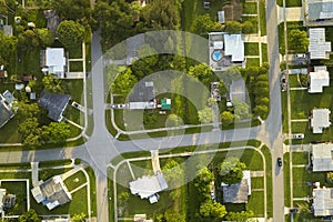 Aerial view of suburban landscape with private homes between green palm trees in Florida quiet residential area in