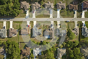 Aerial view of suburban landscape with private homes between green palm trees in Florida quiet residential area