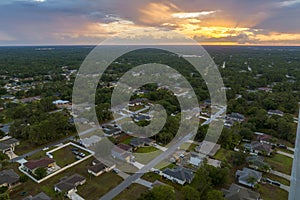 Aerial view of suburban landscape with private homes between green palm trees in Florida quiet residential area in