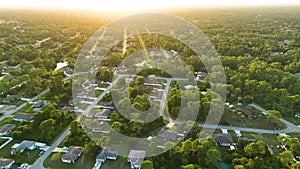 Aerial view of suburban landscape with private homes between green palm trees in Florida quiet residential area in