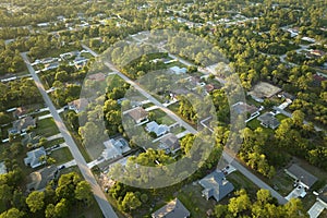 Aerial view of suburban landscape with private homes between green palm trees in Florida quiet residential area