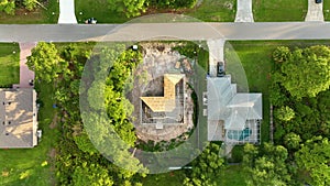 Aerial view of suburban private house wit wooden roof frame under construction in Florida quiet rural area