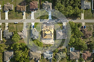 Aerial view of suburban private house wit wooden roof frame under construction in Florida quiet rural area