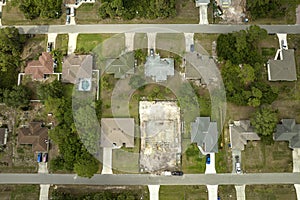 Aerial view of suburban private house wit wooden roof frame under construction in Florida quiet rural area