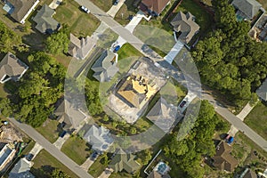 Aerial view of suburban private house wit wooden roof frame under construction in Florida quiet rural area