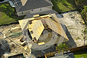 Aerial view of suburban private house wit wooden roof frame under construction in Florida quiet rural area