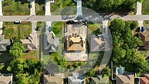 Aerial view of suburban private house wit wooden roof frame under construction in Florida quiet rural area