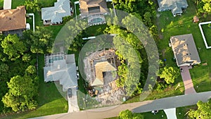 Aerial view of suburban private house wit wooden roof frame under construction in Florida quiet rural area