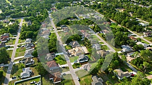 Aerial view of suburban private house wit wooden roof frame under construction in Florida quiet rural area