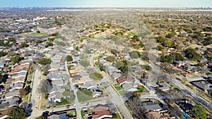 Aerial view suburban residential houses with downtown Dallas in distant background, Master Planned Communities DFW