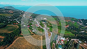 Aerial view on suburban road with cars, trucks and other tranportation in a mountains