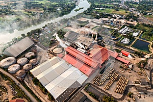 Sugar bioethanol translation factory working with steam from the chimney and sugarcane truck photo