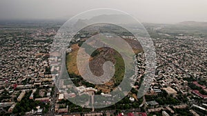 Aerial view of Sulaiman Too Sacred Mountain in Osh city, Kyrgyzstan. The symbol of the city of Osh. Beautiful powerful