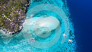 Aerial view of the Sumilon island, sandy beach with tourists swimming in beautiful clear sea water of the Sumilon island beach,