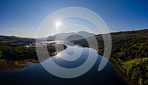 Aerial view of the sun rising above Fort William and the Ben Nevis mountain range in the Scottish Highlands