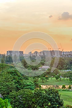 Aerial view sun setting behind park lakeside apartments in Singapore