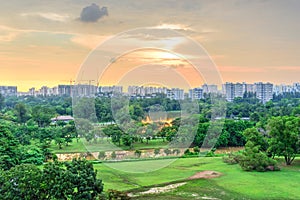 Aerial view sun setting behind park lakeside apartments in Singapore