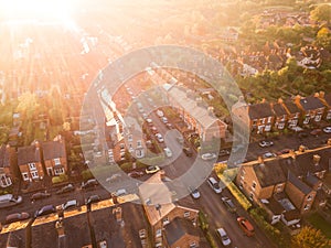Aerial view of the sun setting over a cross roads in a traditional UK suburb