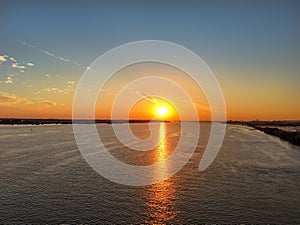 Aerial View of Sun Setting over the Water