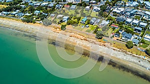 Aerial view on sunny beach with residential houses. Waiheke Island, Auckland, New Zealand