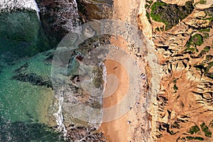 Aerial view of sunny rock and Pacific water at Sunset Cliffs, in San Diego, California