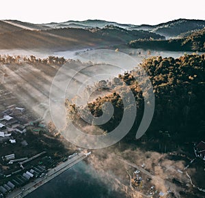 Aerial view of Sunrise with fog over Ban Rak thai, chinese village near a lake in Mae Hong Son, Thailand