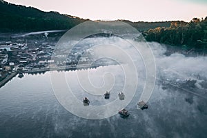 Aerial view of Sunrise with fog over Ban Rak thai, chinese village near a lake in Mae Hong Son, Thailand