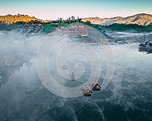 Aerial view of Sunrise with fog over Ban Rak thai, chinese village near a lake in Mae Hong Son, Thailand