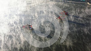 Aerial view of Sunrise with fog over Ban Rak thai, chinese village near a lake in Mae Hong Son, Thailand