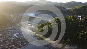 Aerial view of Sunrise with fog over Ban Rak thai, chinese village near a lake in Mae Hong Son, Thailand