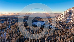 Aerial view of sunrise in the snow covered mountains