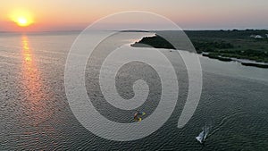 Aerial view of sunset in Hel penisula Jastarnia Puck Bay Baltic Sea. Kitesurfing at sunset. Windsurfing at sunset.