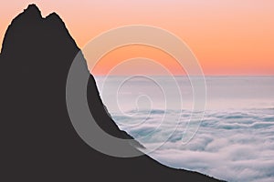Aerial view sunset landscape mountain silhouette above clouds in Norway