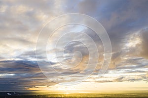 Aerial view sunset over the forest and lake. View from drone. Aerial top view cloudscape. Texture of clouds. View from above. Sunr