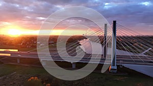 Aerial view Sunset Over Modern Bridge in Krakow, The sun setting behind a modern cable-stayed bridge in Krakow, casting