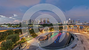 Aerial view after sunset with Singapore city skyline view from Marina barrage garden day to night timelapse.