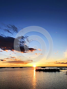 Aerial view of a Sunset sky background. Aerial Dramatic gold sunset sky with evening sky clouds over the sea. Stunning sky clouds