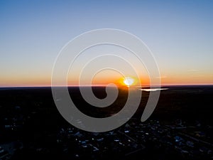 Aerial view of a Sunset sky background. Aerial Dramatic gold sunset sky with evening clouds over the sea. Stunning sky clouds